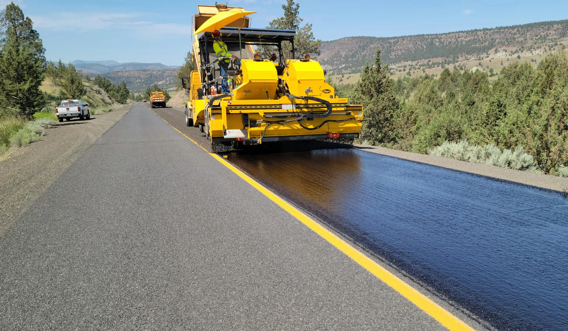 Paving contractor team working on asphalt project in residential neighborhood